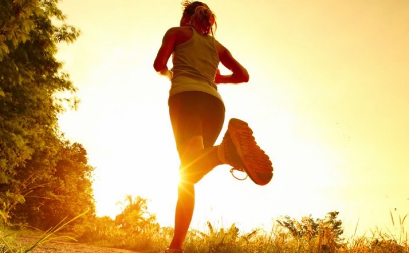 lifestyle image of person running into the sun set