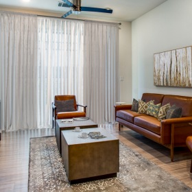 Living Room spacious living room with natural lighting from large windows in senior luxury apartments