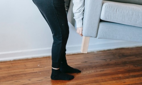 Person lifting a couch 