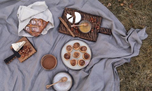 fall food spread on picnic blanket in grass